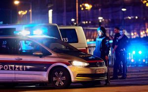 Polizisten stehen neben einem Einsatzwagen in Wien in der Nacht vom 2. auf den 3. November 2020
