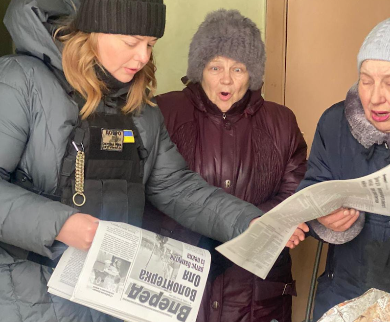 Freiwillige verteilt Zeitung an Leserinnen in Bachmut.