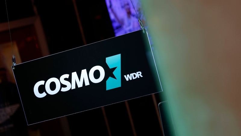 Schild mit dem Logo der Radiosenders Cosmo