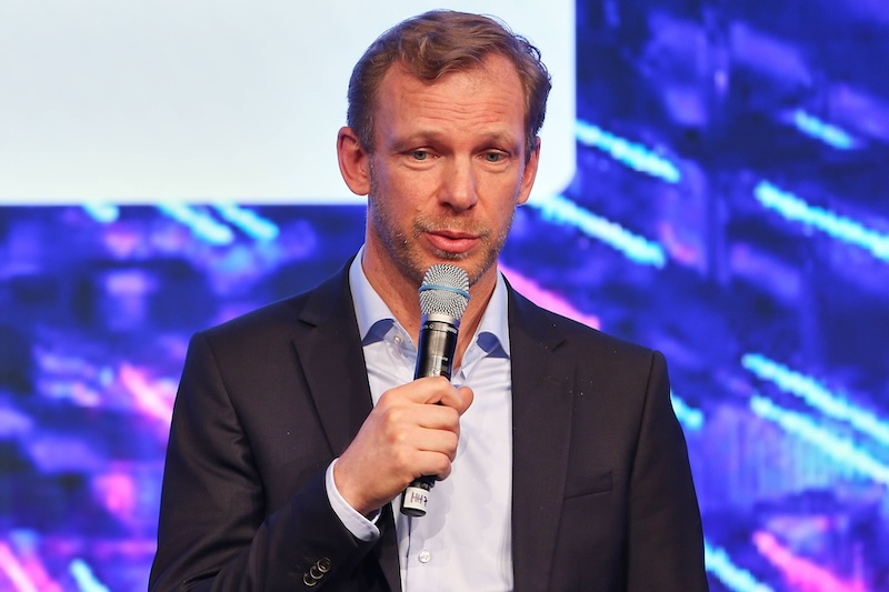 Ippen-Chefredakteur Markus Knall mit einem Mikrofon auf einer Bühne.