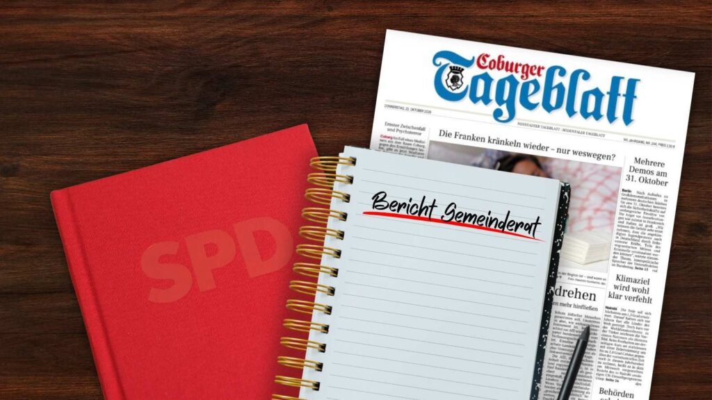 Auf einem Schreibtisch liegen ein SPD-Parteibuch, ein Notizblog sowie eine Ausgabe des „Coburger Tageblatts“.