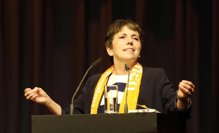 Margot Käßmann steht hinter einem Pult und redet